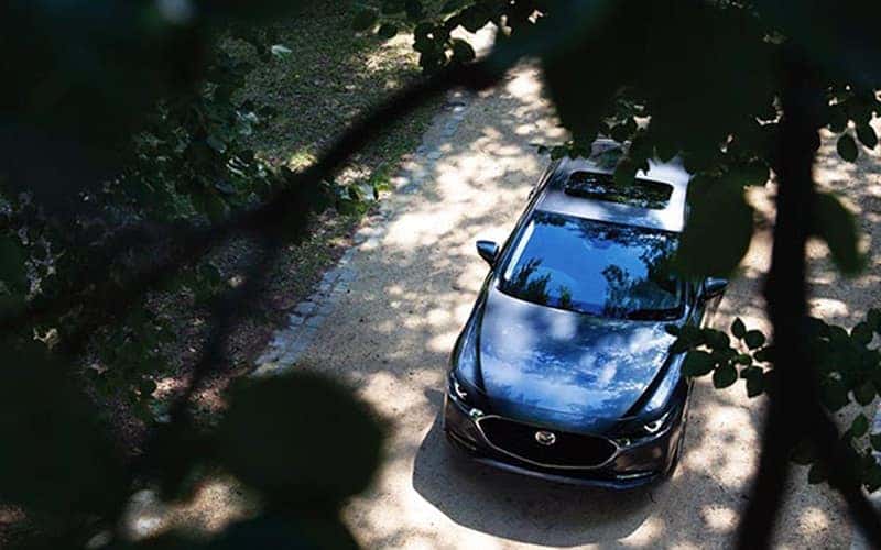 Mazda SUV driving along a path