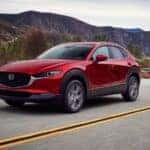 A red 2025 Mazda CX-30 on the road