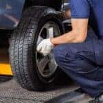 Mechanic working with a proper tire rotation pattern