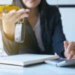 Reviewing Mazda financing options with a notepad and calculator