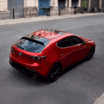 Rearview of the 2026 Mazda3 Hatchback on the road