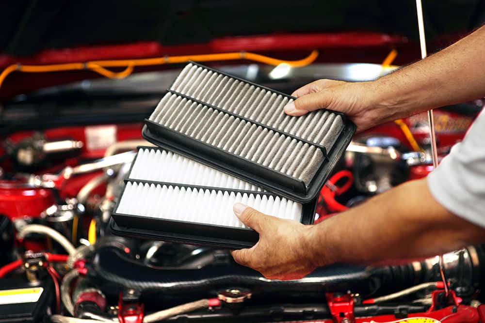 Changing engine air filter as part of a Mazda service schedule