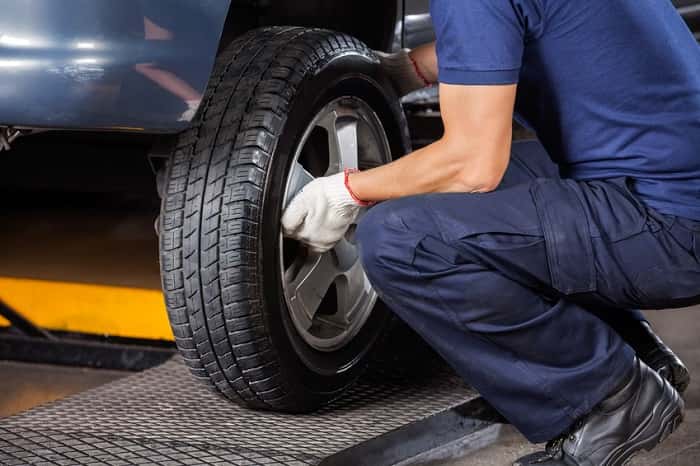 Mechanic demonstrating what is a tire rotation