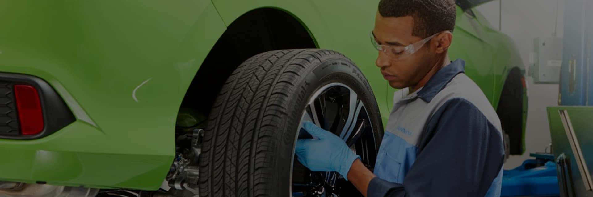 technician working on honda vehicle wheel