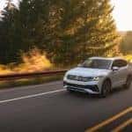A white 2022 Volkswagen Tiguan is shown on a test drive near a Willoughby Hills Volkswagen dealer.