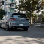 A grey 2022 Volkswagen GTI Autobahn is shown from the rear leaving a Cleveland Heights car dealership.