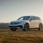 A white 2022 Volkswagen Tiguan is shown from the front at an angle while parked in a field after leaving a Cleveland VW dealer.