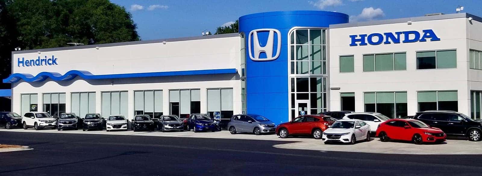 An exterior shot of a Honda dealership in the day.