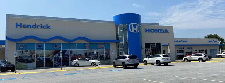 An exterior shot of a Honda dealership in the day.