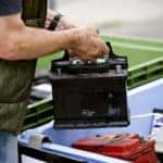 Man Holding a Car Battery