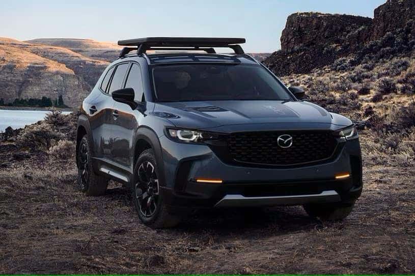 exterior image of mazda cx-50 with roof rack sitting in desert