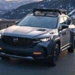 Mazda Cx-5 with roof rack driving down road. Carbon edition