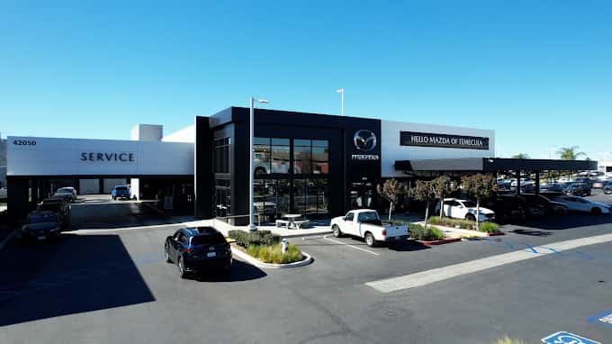 exterior image of Hello Mazda of Temecula with car driving thru service drive