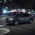 2024 Mazda CX-5 driving down the road at night.