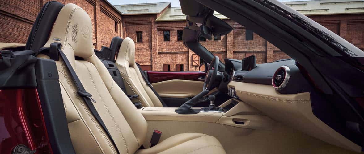 Tan interior of a red mazda miata