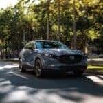 CX-30 driving down a tree lined street
