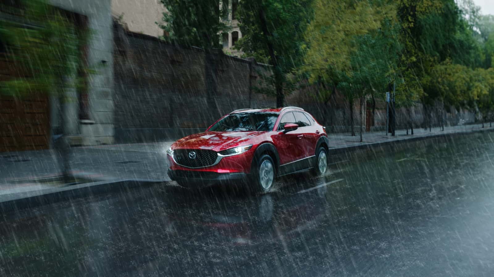 A red 2025 Mazda CX-30 in the rain