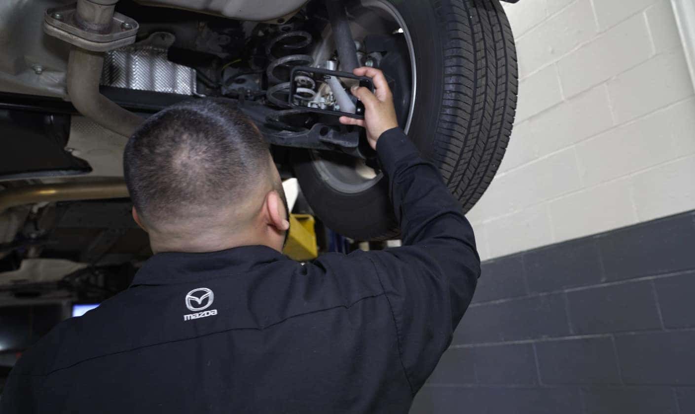 Mazda technician performing a vehicle inspection