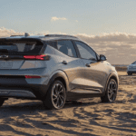 A gray Chevrolet Bolt EUV parked on the beach.