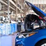 Chevy Technician Inspecting Engine