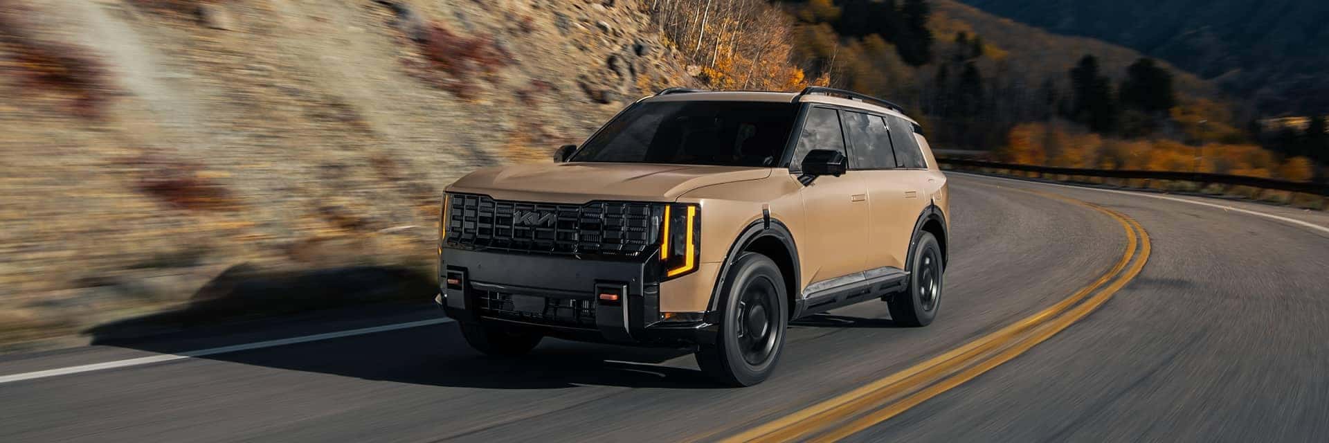 2027 Kia telluride driving by mountains