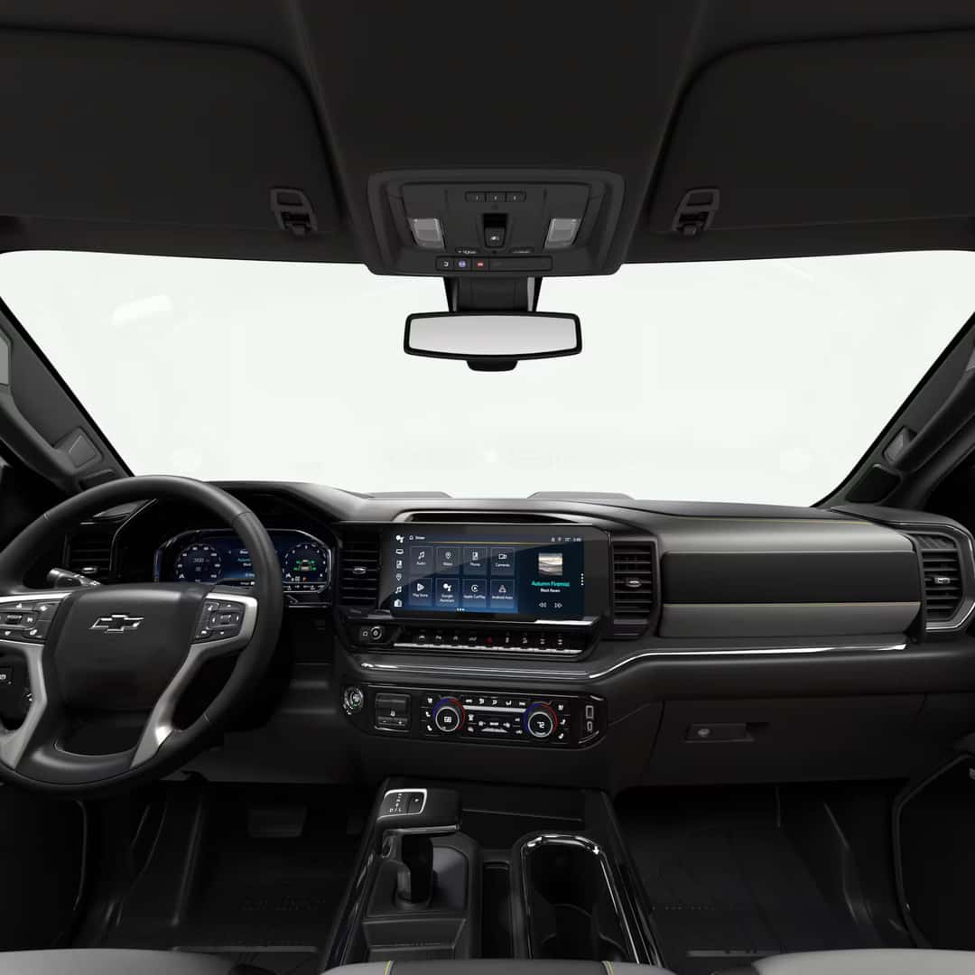 the front interior of a silverado truck showing the infotainment and digital display