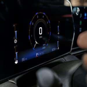 Close-up of the digital driver display in the 2025 Chevrolet Trailblazer, showing a clear speedometer, RPM gauge, and fuel level, with a driver’s hand on the steering wheel.