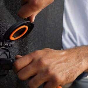 Close-up of a hand plugging in a power tool to the bed-mounted power outlet in a Chevrolet Colorado.