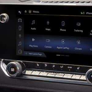 Infotainment screen in a pickup truck showing multiple features, including audio, navigation, phone, and app connectivity.