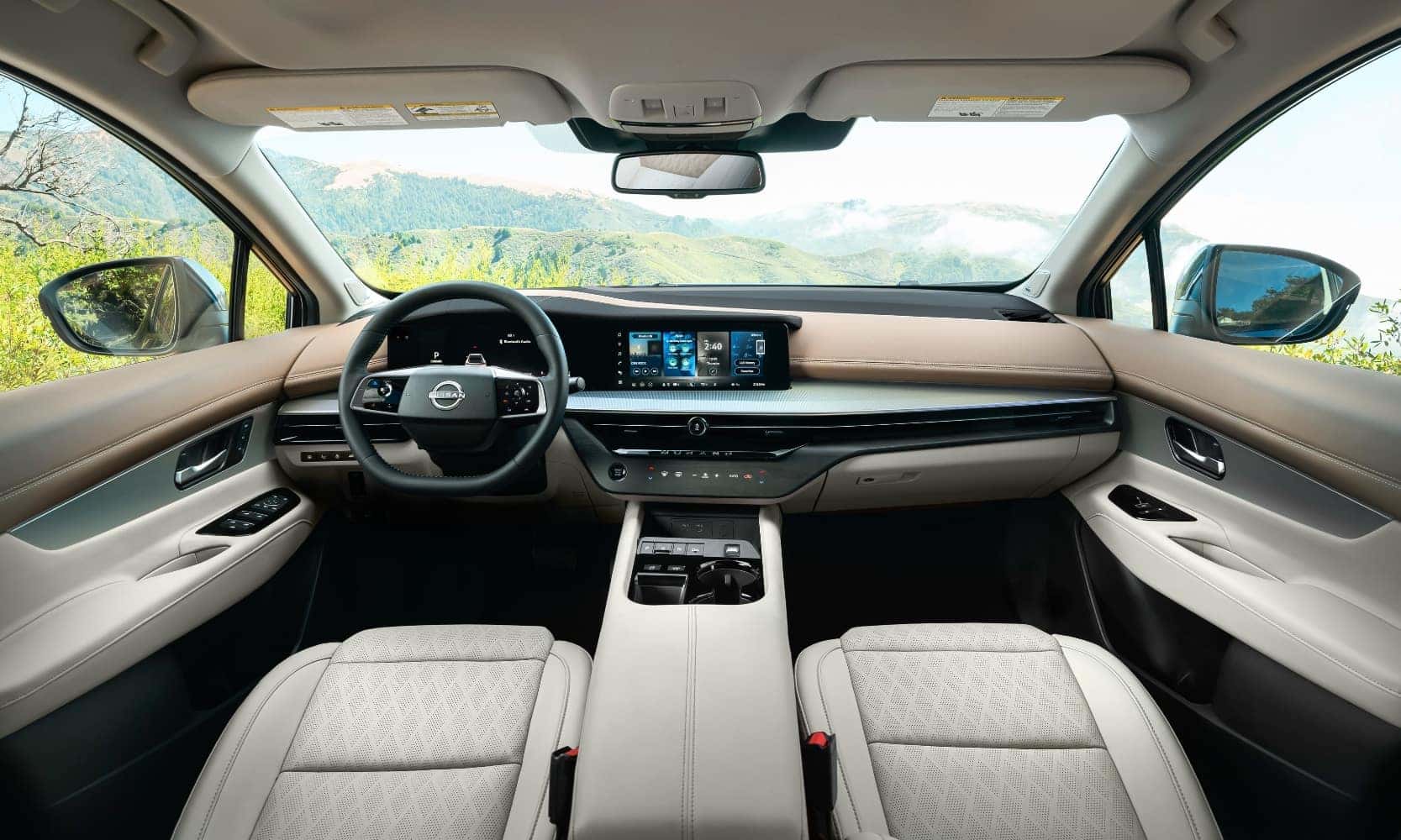 front interior dashboard, steering wheel, and infotainment system inside the 2025 Nissan Murano SUV