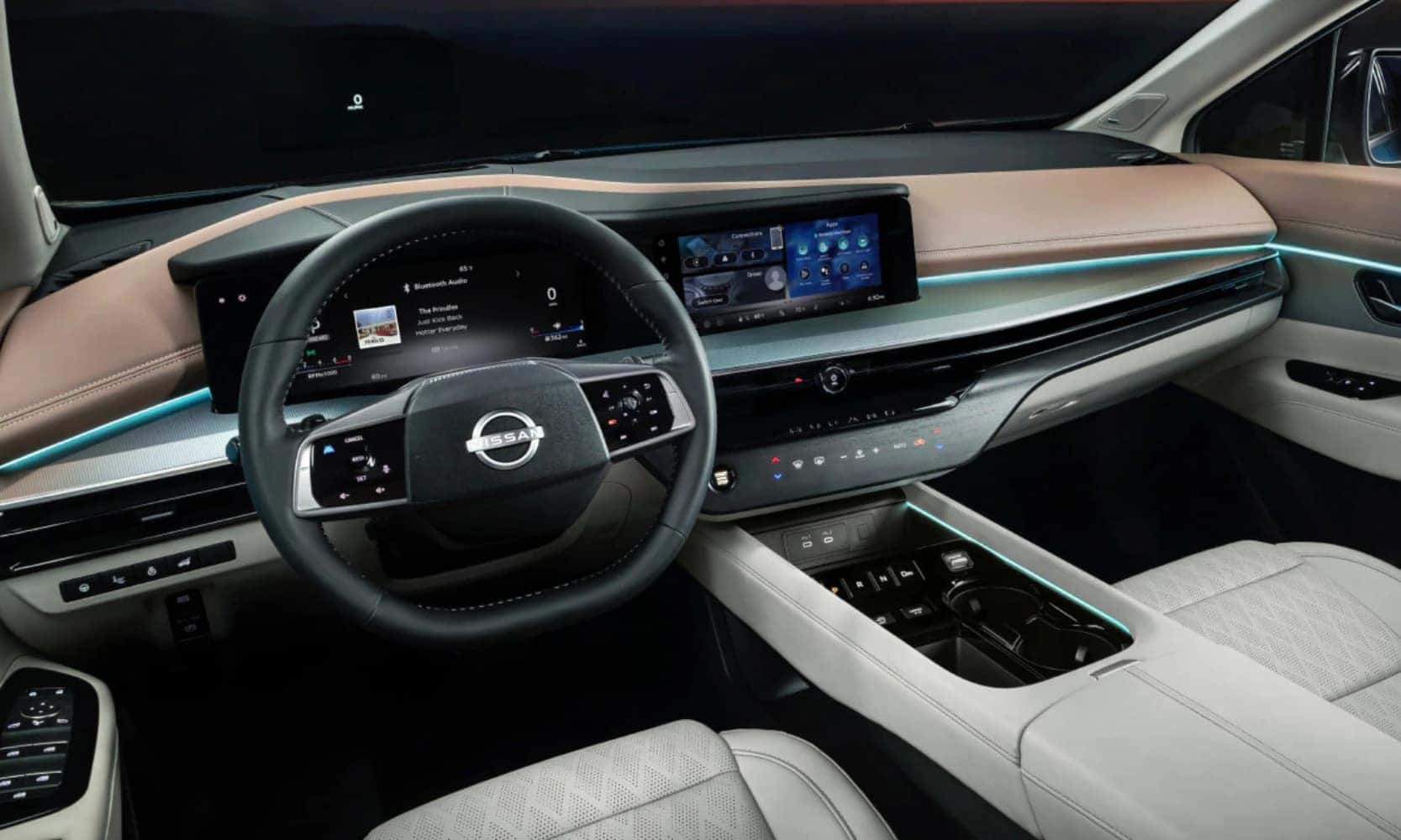 Interior image of a 2025 Nissan Murano’s white and tan front seat area, infotainment system, and dashboard