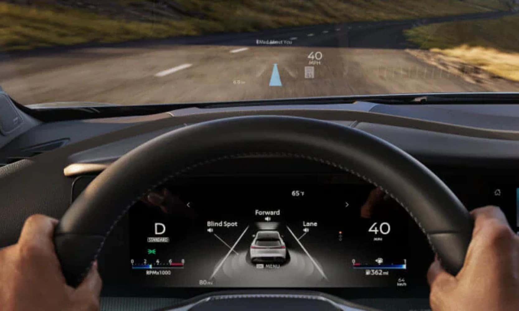 Closeup interior image of a 2025 Nissan Murano steering wheel with the driver’s hands, dashboard, and Head-Up windshield display of safety driving features