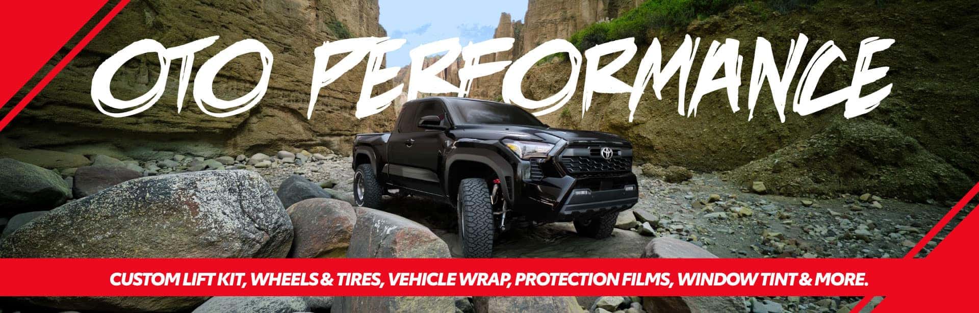 Lifted Toyota Truck Driving Though a Dry Riverbed