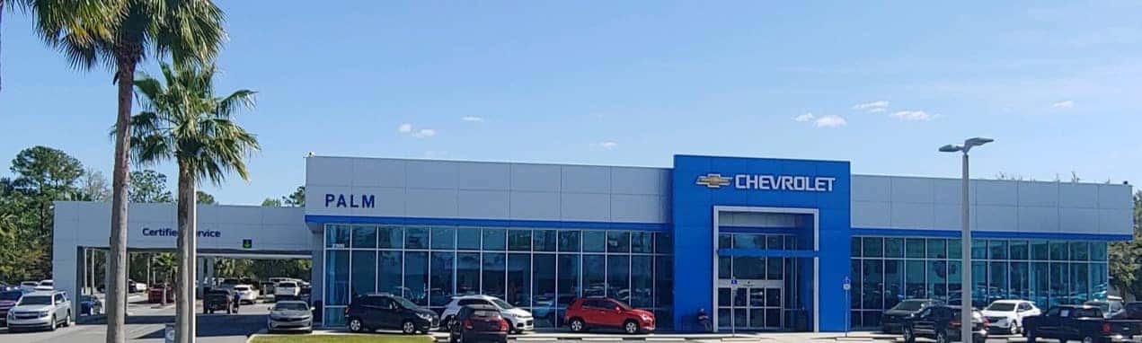 An exterior shot of a Chevrolet dealership at night.