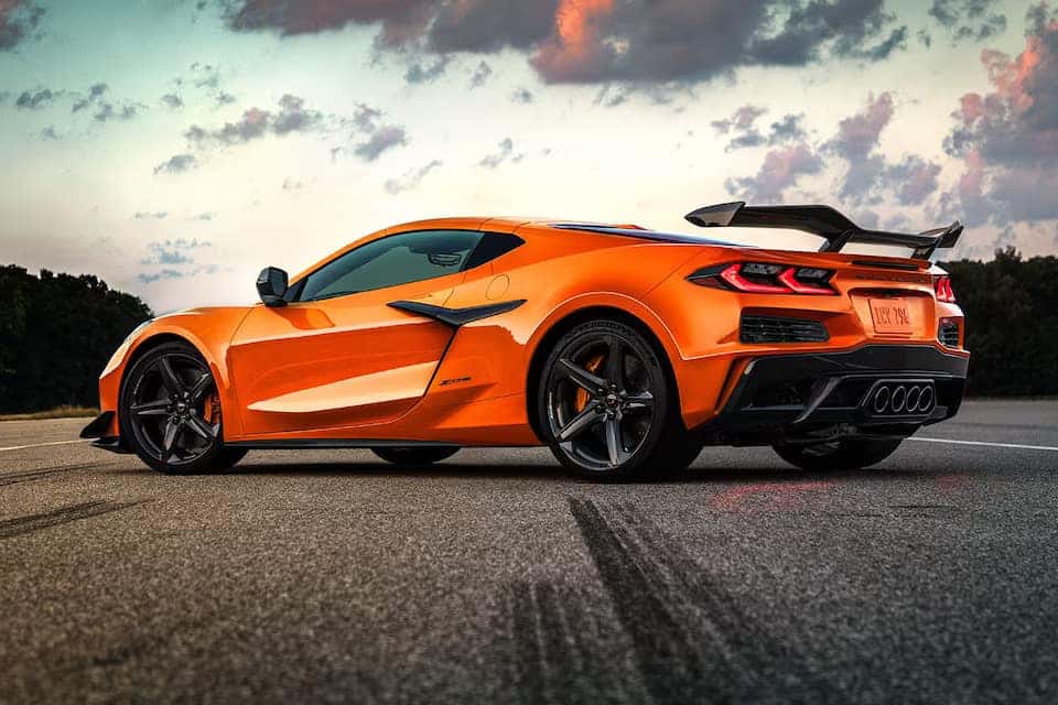an orange sports car on the road