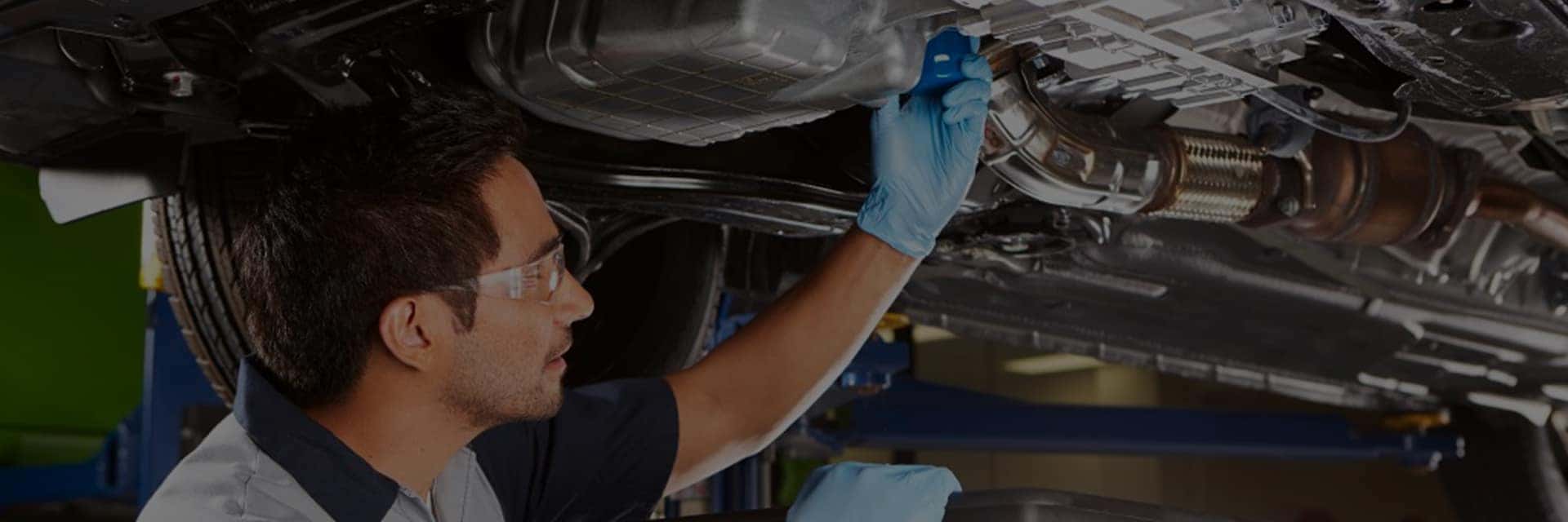 honda service technician working on vehicle