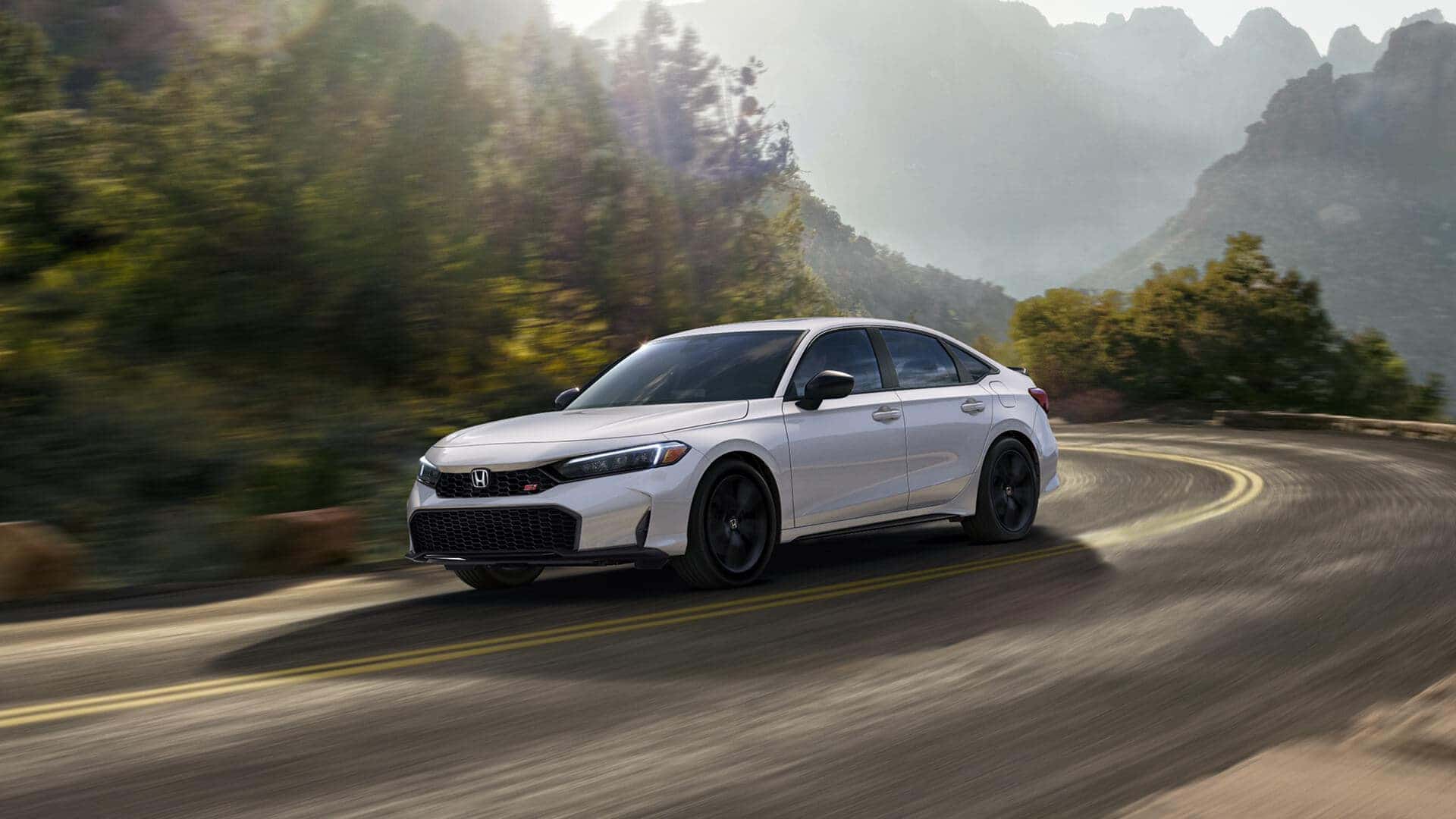2025 honda civic driving down a stretch of highway