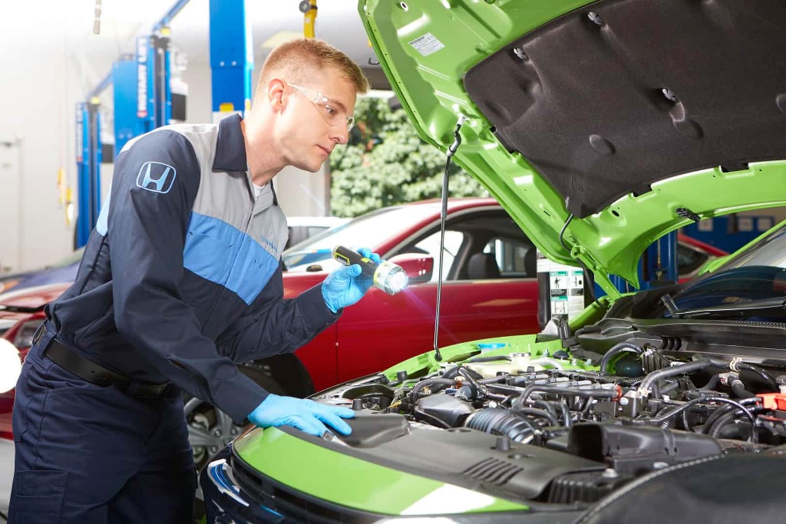 honda tech servicing a vehicle