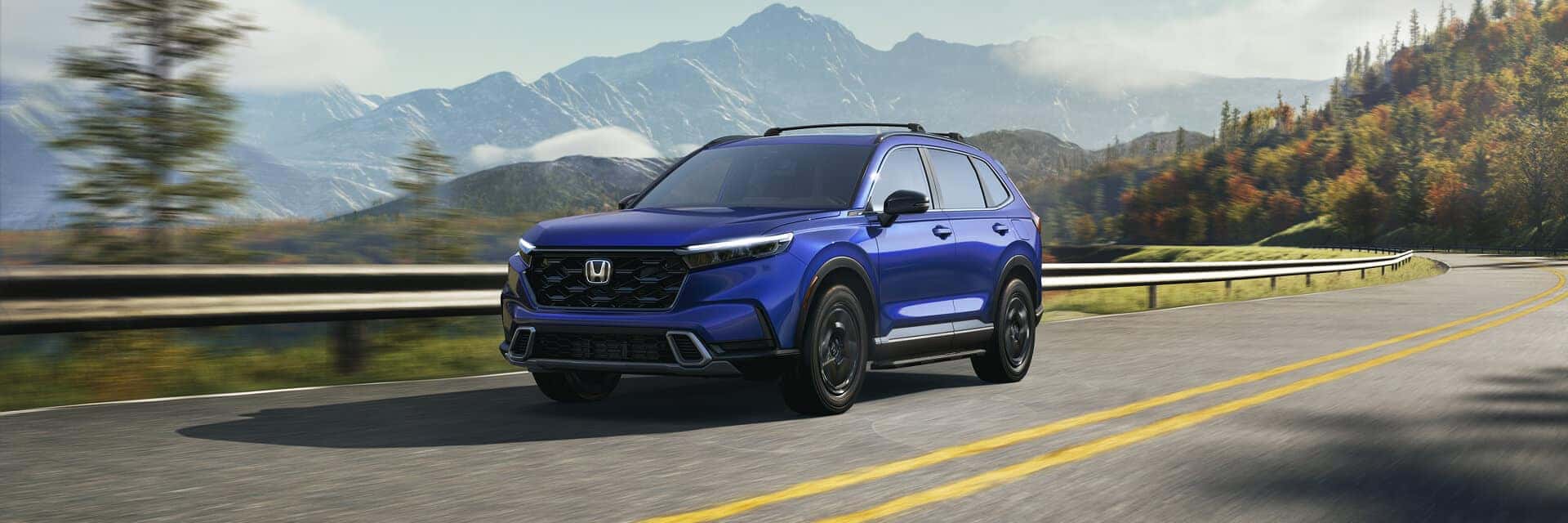2025 honda cr-v driving on highway with mountains in background