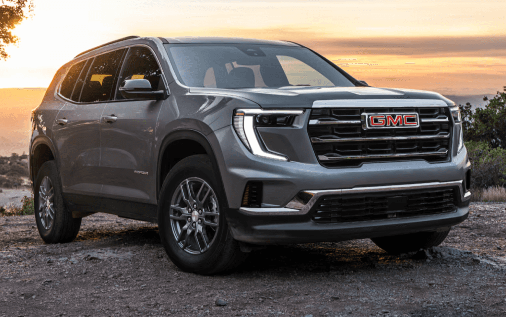 GMC Acadia parked in front of sunset