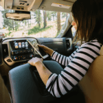 Lady using phone in her GMC vehicle