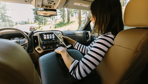 Lady using phone in her GMC vehicle