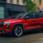 Red Chevrolet Equinox driving on a city street