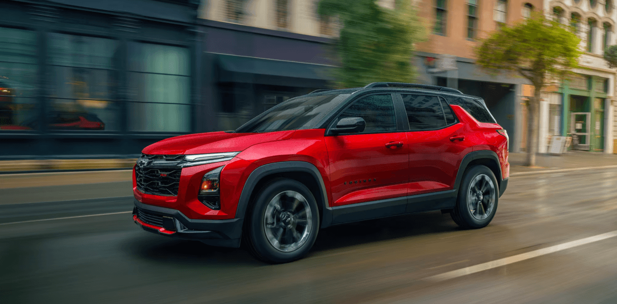 Red Chevrolet Equinox driving on a city street