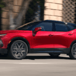 A red Chevrolet Blazer crossover driving on a city street