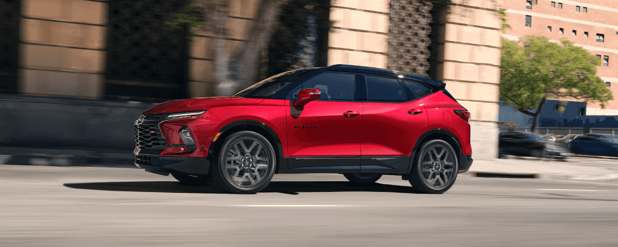 A red Chevrolet Blazer crossover driving on a city street