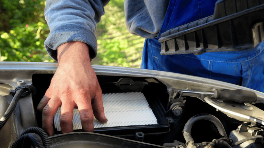 Man installing Engine Air Filter.