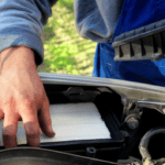 Man installing Engine Air Filter.
