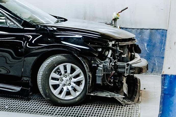 Uftring Weston Body Shop image of a vehicle being taken apart - Uftring Weston Body Shop Image