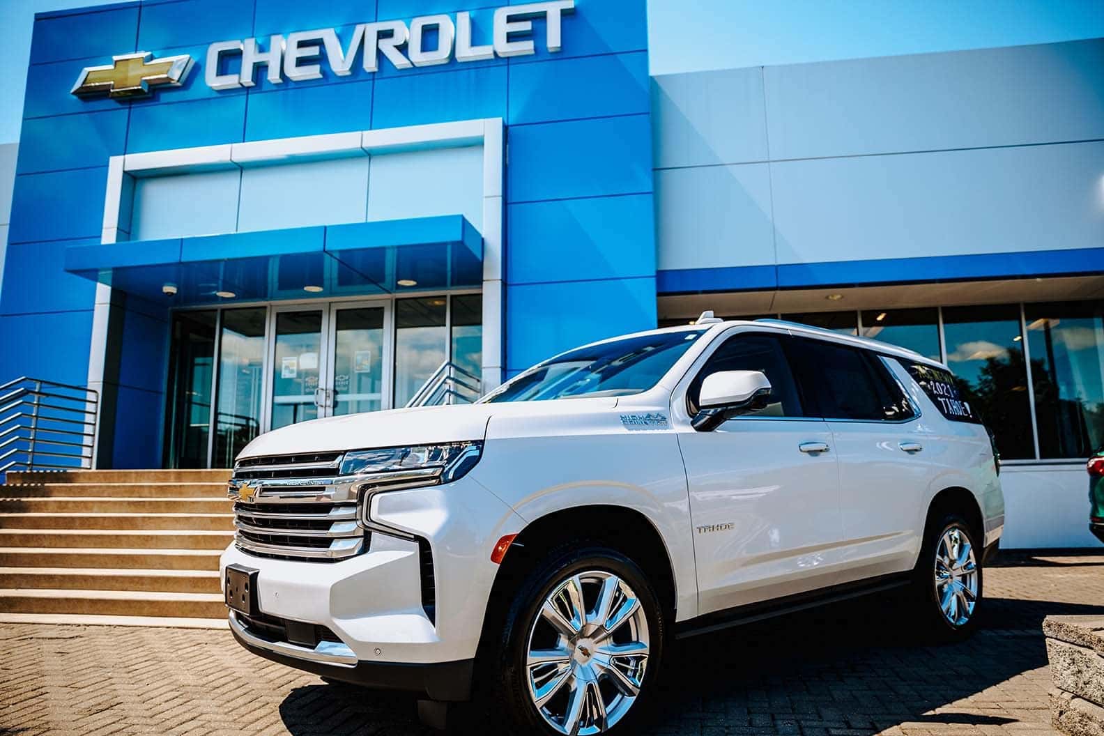 An exterior shot of a Chevrolet dealership at night.